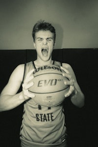 a black and white photo of a man holding a basketball