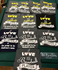 a table full of t - shirts that say i love softball player