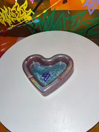 a heart shaped ashtray on a white table