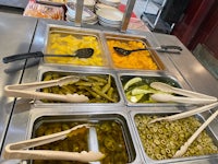 trays of pickles on a counter