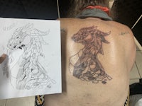 a woman's back with a drawing of a dragon