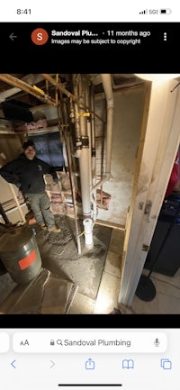 a man is standing in a room with pipes