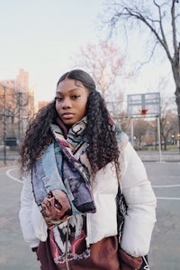 a young woman wearing a scarf on a basketball court