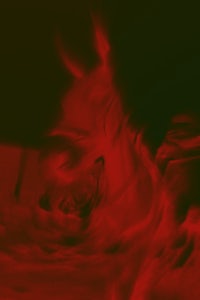 a black and red image of a swirling red liquid