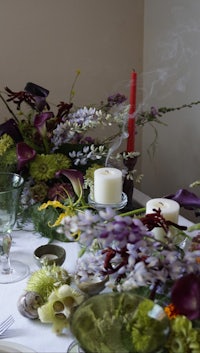 a table set with flowers and candles