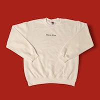 a white sweatshirt with the word good luck on it