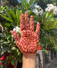 a woman's hand with henna painted on it