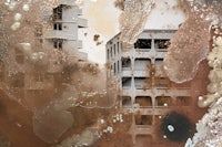 a painting of a building with rust on it