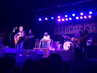 a group of people on stage at a concert
