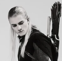 a black and white photo of a man with a bow and arrow