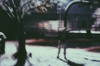 a person walking down a snowy street at night