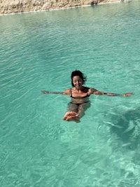a woman in a bikini floating in clear water