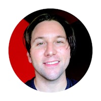 a man smiling in front of a red circle