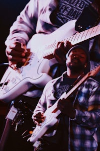 a man is playing an electric guitar