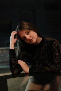 a woman sitting on a glass table