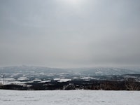 a skier is standing on a snow covered slope