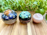 three glass spheres sitting on a wooden table