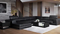 a black leather sectional sofa in a living room