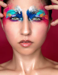 a woman with colorful makeup on her face