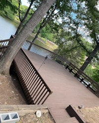 a wooden deck with a view of a lake