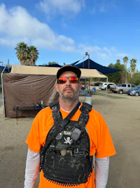 a man wearing an orange shirt