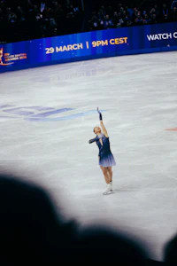 a woman is on a ice skating rink