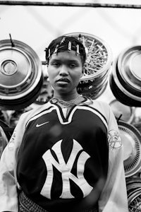a black and white photo of a woman in a yankees jersey