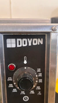 a doyon coffee machine with a red light on it