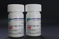 two bottles of clonidine tablets on a black background