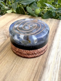a box with a spiral design on top of a wooden table