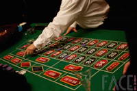 a man is playing a roule at a casino