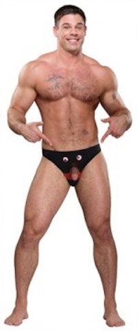 a man in a black thong posing for the camera