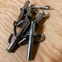 a group of metal hooks on a wooden table