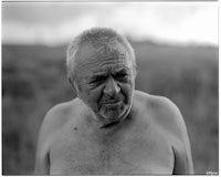 a black and white photo of a man in a field