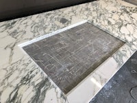 a white marble countertop with a wooden frame