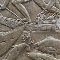 an egyptian relief depicting a man fishing in a boat