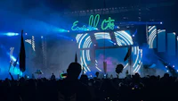 a crowd of people at a music festival at night