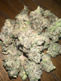 a bunch of marijuana on top of a wooden table