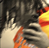 a person with dreadlocks holding a cell phone