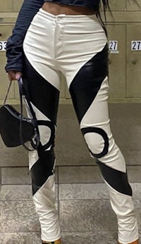 a woman in black and white pants posing for a photo