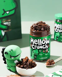 mellow crunch is a green dinosaur with a jar of chocolate