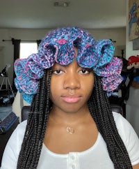 a woman wearing a crocheted ruffled hat