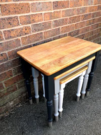 a table with two legs and a wooden top