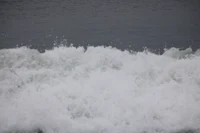 a surfer riding a wave in the ocean