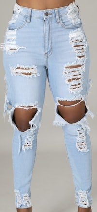 a woman wearing ripped jeans with holes in the knees