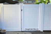 a white vinyl fence in a backyard