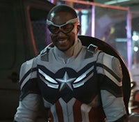 captain america is standing in front of a car