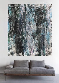 an abstract painting on a wall in a living room
