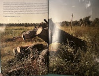 a book with a picture of a tree in the middle of a field