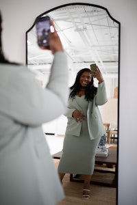 a woman taking a selfie in a mirror